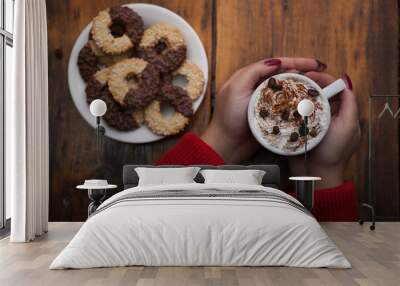 Female hands holding cups of coffee on rustic wooden table backg Wall mural