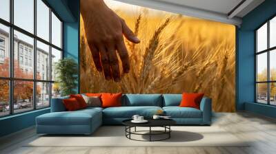 Wheat field.Female hand stroking touches of ripe ears of wheat.Rich harvest Concept. Beautiful Nature Sunset Landscape.Sunny day in the countryside. Wall mural