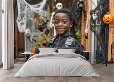 A young teenager black boy,he attends a Halloween party filled with surprises and spooky Halloween elements. clutching a bag of freshly won candy and looking forward  funny game or prank.  Wall mural