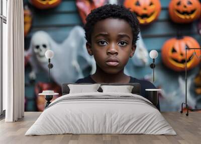 A young teenager black boy,he attends a Halloween party filled with surprises and spooky Halloween elements. clutching a bag of freshly won candy and looking forward  funny game or prank.  Wall mural