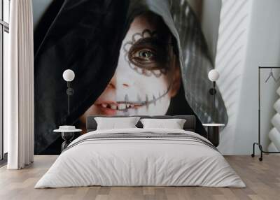 Scary boy celebrating halloweenday of the dead terrifying skull face makeup for eyes mouth Wall mural