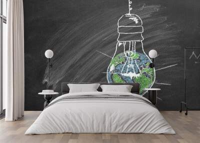 A light bulb with a globe inside, drawn in chalk on a school chalkboard. Earth hour concept. Save the world. Save our planet. Wall mural