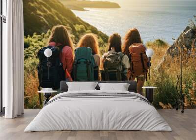 A group of backpacking friends on vacation while hiking in the countryside by the sea Wall mural