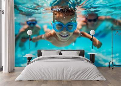 A little boy and his family swim underwater in a swimming pool during summer vacation Wall mural