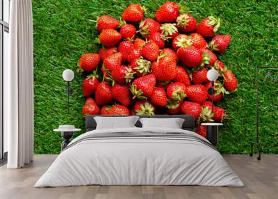 red fresh strawberries on green grass, close view Wall mural