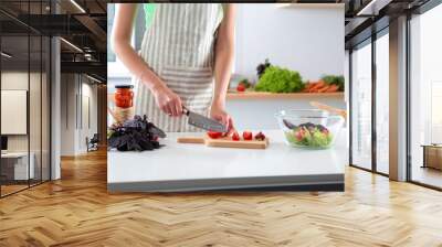 Fresh vegetables on the cutting board are falling in the pot, concept of cooking Wall mural