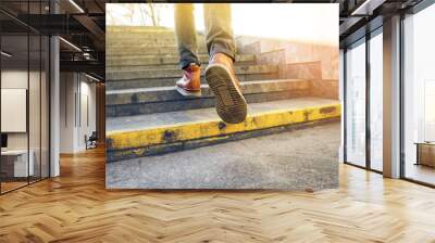 Man in beautiful brown leather shoes walks the granite stairs in an urban environment. Blank background. Life in motion concept Wall mural