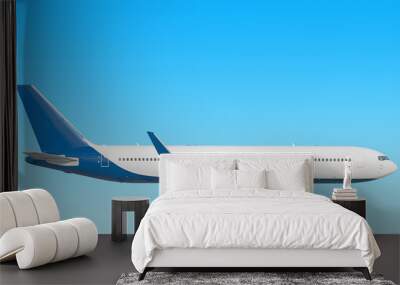 modern airplane side view isolated on blue sky background Passenger jet plane with gear up Commercial aircraft blue tail paint scheme Luxury business jet flying in air Aviation design reference Wall mural