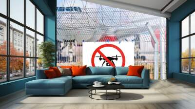 no drone sign on airport security fence against passenger airplane on runway blurred background Copy space mockup for air travel safety transportation concept Wall mural