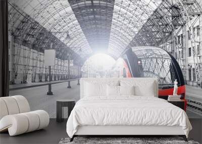 railway train station interior wide view of historical railroad transportation building in Moscow city Russia with modern train arriving to platform black and white retro stylized background Wall mural