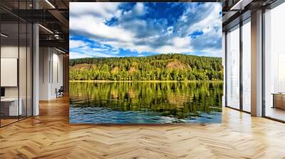 Scenic view on sloped green forestry bank of russia east siberia Yenisei river near krasnoyarsk city with scenery blue sky clouds reflection on still water wonderland panoramic nature background Wall mural