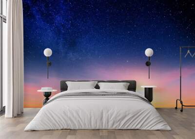 Sunset sky with orange setting sun and red clouds landscape against bright star on black universe background. Wide panorama view of stars in space nature at dark time. Starry night at night wallpaper Wall mural