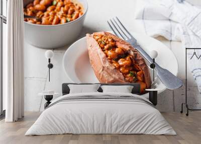 Baked sweet potato stuffed with beans in tomato sauce. Wall mural