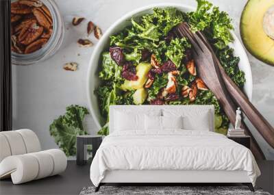 Green kale salad with cranberries and avocado in white bowl, top view. Healthy vegan food concept. Wall mural