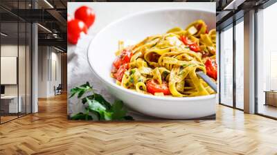 Green spinach pasta with tomatoes and herbs. Healthy vegan food concept. Wall mural