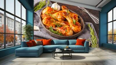 Grilled spicy chicken legs baked with garlic, rosemary and thyme on dark background. Wall mural