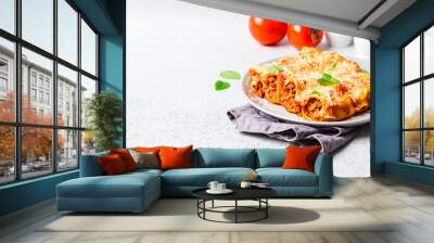 Portion of cannelloni with meat, tomato sauce and cheese on gray plate, gray background. Italian cuisine concept. Wall mural