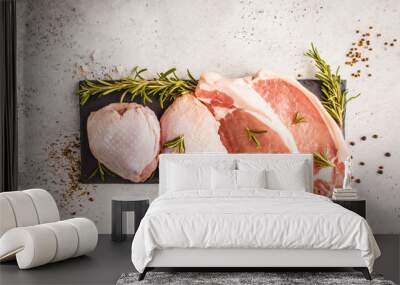 Raw chicken and pork on slate with spices. White background, top view, copy space. Wall mural