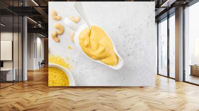 Vegan Cashew Cheese Sauce in white sauceboat, white background, top view. Wall mural