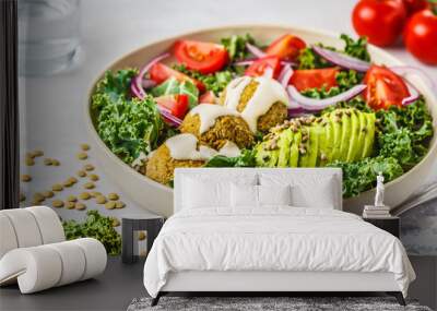 Vegan lentil meatballs salad with kale, avocado, tomato and tahini dressing. Wall mural