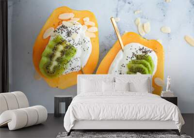 Yogurt papaya boat with kiwi, chia seeds and almonds. Healthy summer food. Wall mural