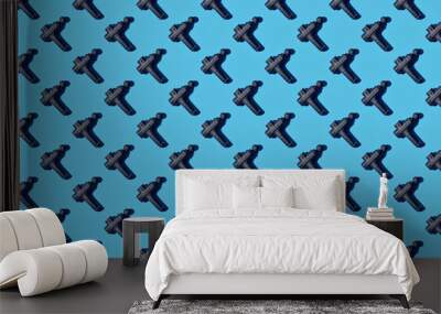 Pattern of massage gun on blue background Wall mural