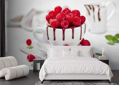 Raspberry mug cake in a white ceramic mug on white background Wall mural