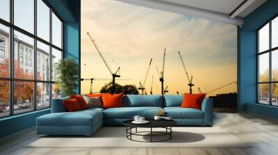 Construction cranes in evening Wall mural