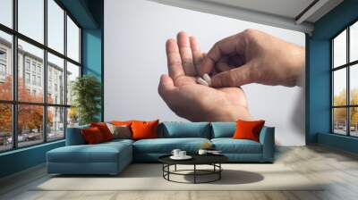 Male hands holding pills for treat illness Wall mural