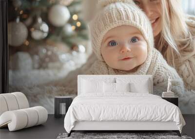 Cute little girl in sweater at home on Christmas eve, looking at camera. Portrait of cute little girl in knitted sweater on Christmas background. Wall mural