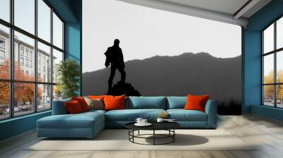 Black and white silhouette of hiker on the top of the hill Wall mural