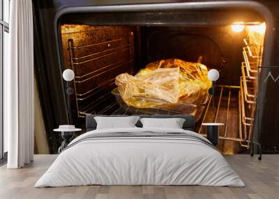 the duck is baked in an electric oven in a cooking bag Wall mural