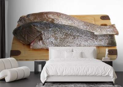 two scaled grouper fish on bamboo cutting board isolated Wall mural