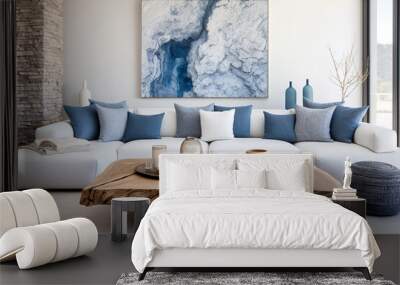 Live edge accent coffee table near white sofa with blue pillows against wall with big poster frame. Coastal home interior design of modern living room. Wall mural