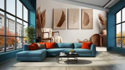 Wooden armchair near white stucco wall with three posters. Boho interior design with home decor. Created with generative AI Wall mural