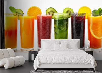 Glasses with fresh organic detox juices of mango kiwi orange strawberries and mint on white background Wall mural