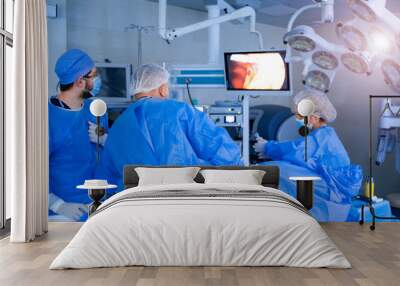 Group of surgeons in operating room with surgery equipment. Medical background Wall mural