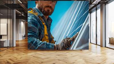 Man installing solar panels on a rooftop under a clear sky. A worker focused on installing solar panels on a sunny day, showcasing dedication and efficiency in renewable energy efforts. Wall mural