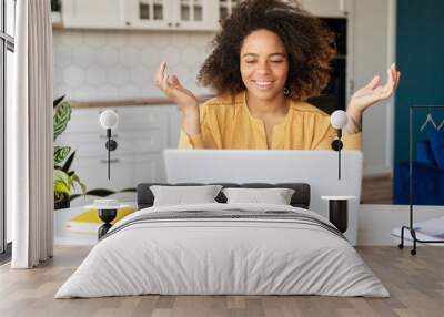 Smiling African-American young woman holding video call, using laptop for online communication with colleagues, female student takes a part in online courses. Telecommuting, tutoring online Wall mural