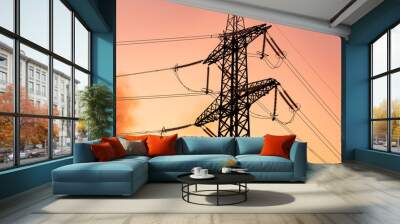 Silhouette of electrical transmission towers. High voltage tower shadow on orange color sunset. Wall mural