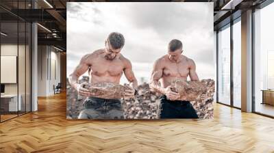 Strong muscular couple of men with naked torso working hard outdoor. Sexy athlete shirtless men. Wall mural