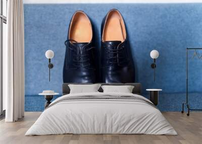 The pair of black leather shoes on a blue background. Closeup. Groom's morning. Wall mural