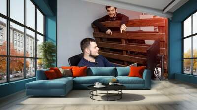 Two men working in a modern office. Achieving the best results. Two confident young men are discussing business plans Wall mural