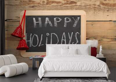 Handwritten happy holidays greeting on a small chalkboard with c Wall mural