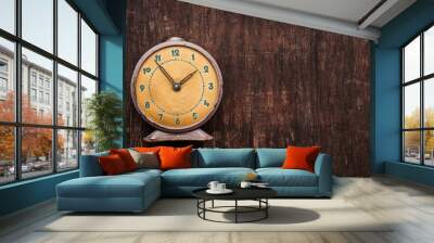 Vintage background with retro alarm clock on table Wall mural