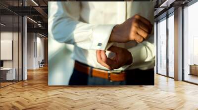 Сlose up of a man in white shirt and cufflink. Man's hands. Groom photosession. Wedding pictures. Wall mural