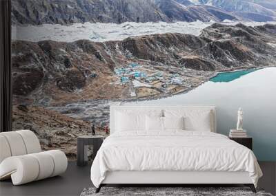 Tourists look at the Gokyo Ri in the glacier, village, and the third lake - Nepal, Himalayas Wall mural