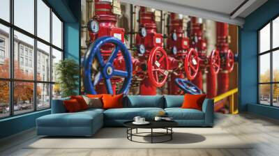 blue and red valves on the background of pipes in the production room Wall mural