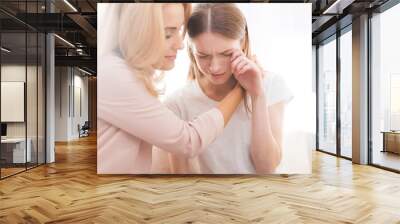 A woman comforts a teenage daughter. Wall mural