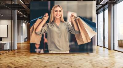 Attractive girl going shopping Wall mural